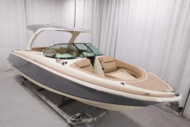 Slide: The Image of 2026 Chris-Craft Launch 31 GT boat in showroom, featuring sleek design and luxury seating. - 3