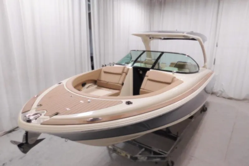 Slide: The Image of 2026 Chris-Craft Launch 31 GT boat in showroom, featuring sleek design and luxurious seating. - 5