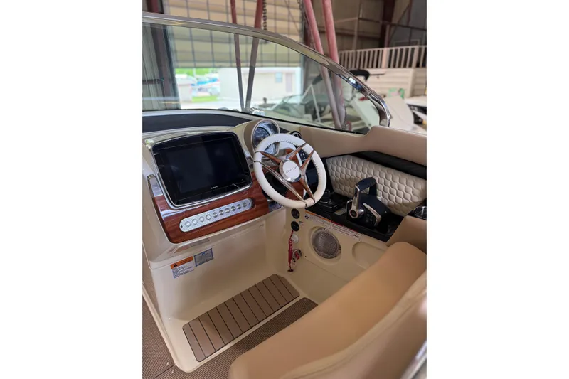 Slide: The Image of 2026 Chris-Craft Launch 31 GT cockpit with modern steering and control panel. - 6