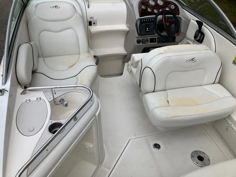 Slide: The Image of Interior of a 2006 Monterey 250 SC boat with white seating. - 14