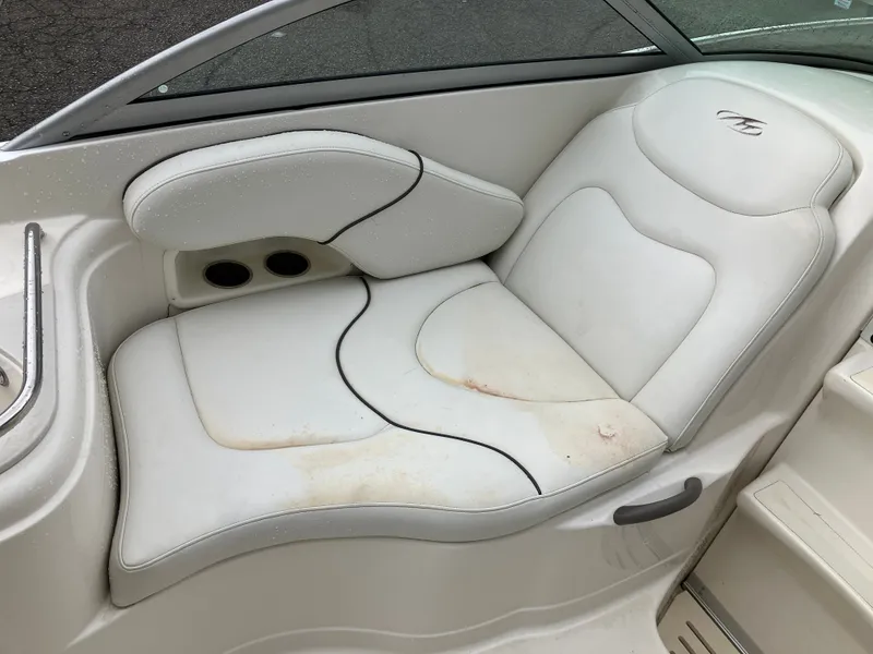Slide: The Image of Interior of a 2006 Monterey 250 SC boat with white seating. - 17