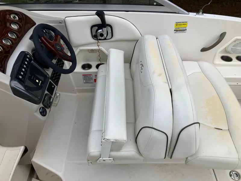 Slide: The Image of Interior of a 2006 Monterey 250 SC boat with steering console. - 18