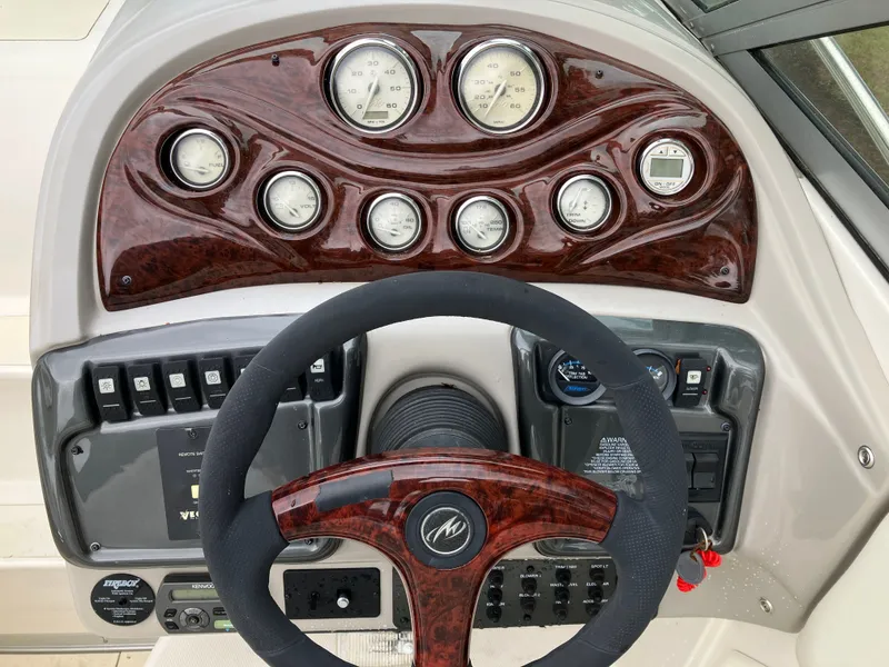 Slide: The Image of Dashboard of a 2006 Monterey 250 SC boat with wood paneling. - 19