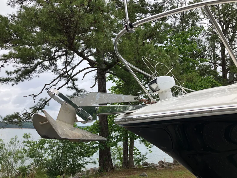 Slide: The Image of 2006 Monterey 250 SC boat with anchor and forested background. - 2
