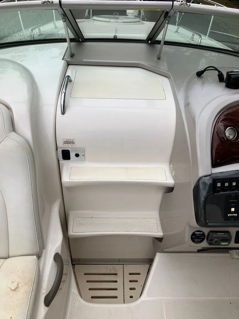 Slide: The Image of Interior of a 2006 Monterey 250 SC boat, helm console and seating area. - 20