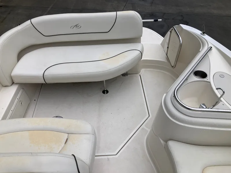 Slide: The Image of Interior of a 2006 Monterey 250 SC boat with white seating. - 23