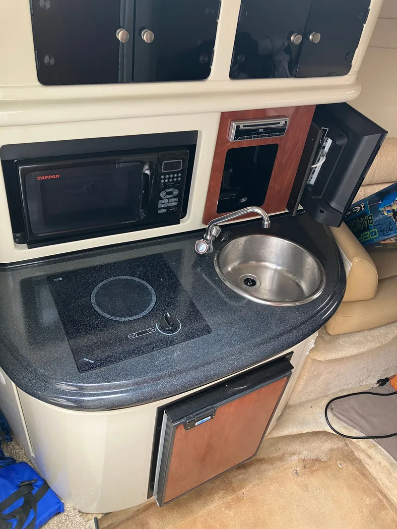 Slide: The Image of Galley kitchen in a 2006 Monterey 250 SC boat. - 26