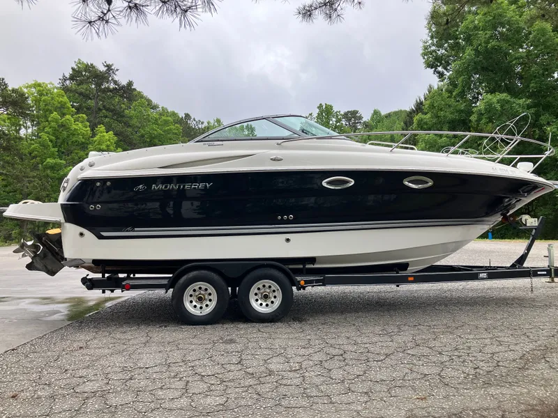 Slide: The Image of 2006 Monterey 250 SC boat parked on trailer outdoors. - 6