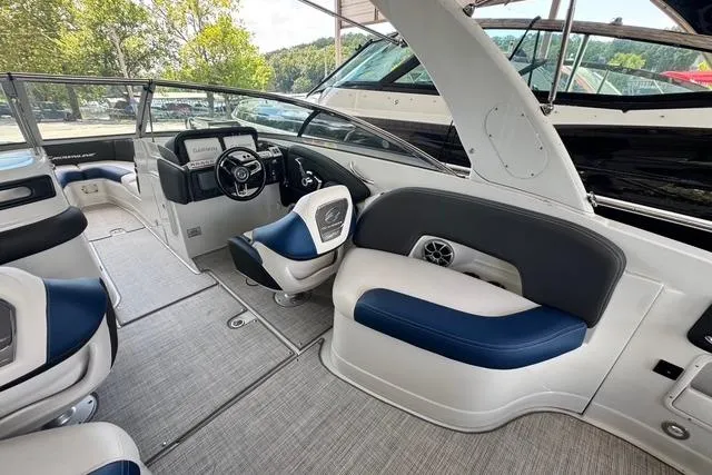 Slide: The Image of 2024 Crownline 290 SS boat interior with modern seating and steering console. - 6
