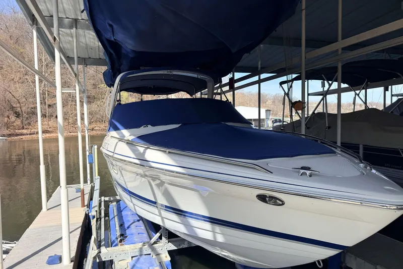 Slide: The Image of 2005 Formula 280 Bowrider boat docked under a covered marina. - 2