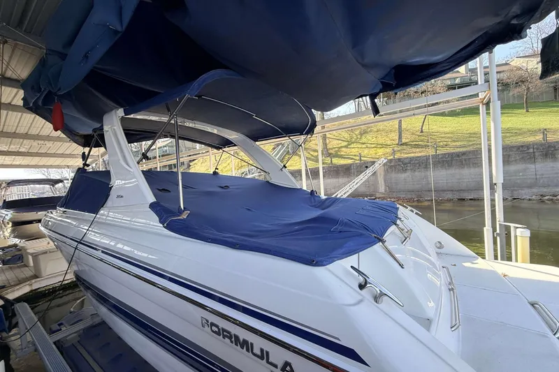 Slide: The Image of 2005 Formula 280 Bowrider boat docked with blue cover and canopy. - 3