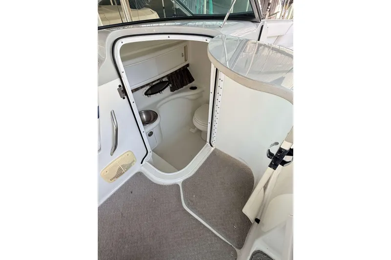 Slide: The Image of Interior view of a 2005 Formula 280 Bowrider boat's compact bathroom area. - 7
