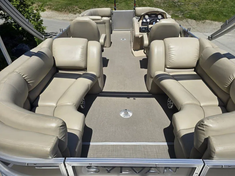 Slide: The Image of Interior of a 2015 Sylvan Mirage 8522 pontoon boat with beige leather seating. - 20