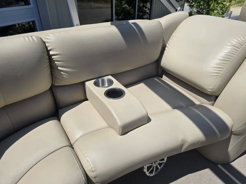Slide: The Image of Beige leather seating with cup holders on 2015 Sylvan Mirage 8522. - 23