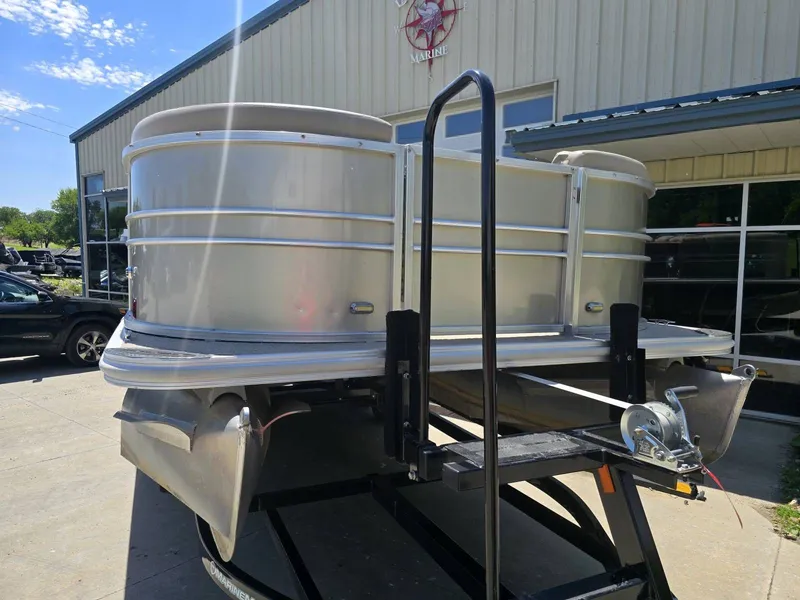 Slide: The Image of 2015 Sylvan Mirage 8522 pontoon boat on trailer outside building. - 8