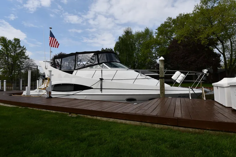 The Image of 2000 Carver 350 Mariner yacht docked, featuring sleek design and American flag. - 1