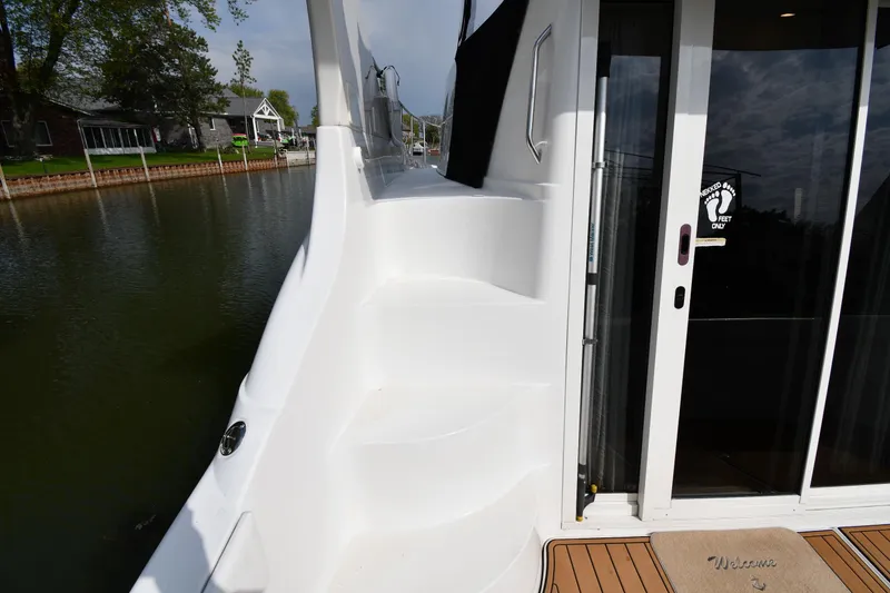 Slide: The Image of Stairway on 2000 Carver 350 Mariner yacht, leading to upper deck, docked by waterfront. - 10