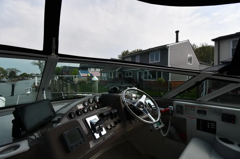 Slide: The Image of Interior view of 2000 Carver 350 Mariner yacht cockpit with steering wheel and control panel. - 13