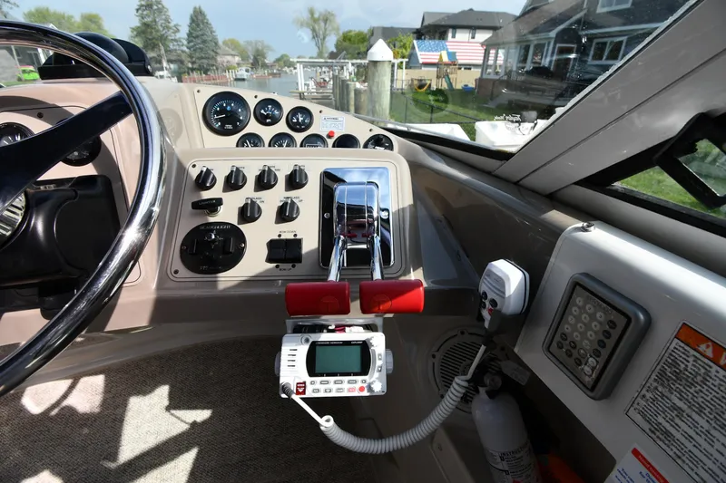 Slide: The Image of Cockpit of 2000 Carver 350 Mariner boat with control panel and steering wheel. - 15