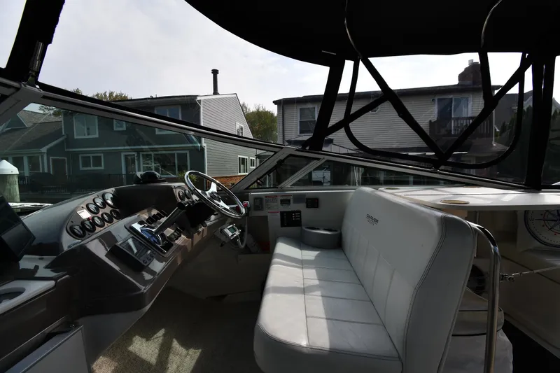 Slide: The Image of Interior view of a 2000 Carver 350 Mariner boat cockpit with steering wheel and gauges. - 18