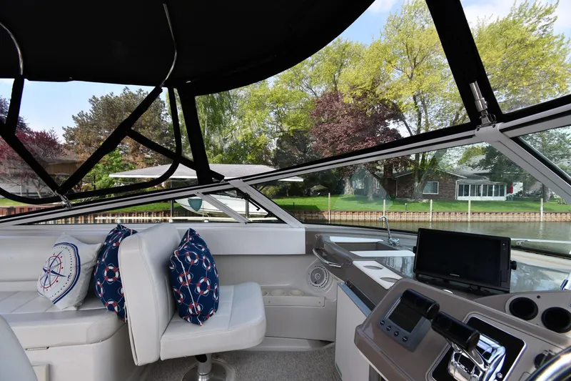 Slide: The Image of Interior of 2000 Carver 350 Mariner yacht with helm, seating, and nautical-themed pillows. - 19