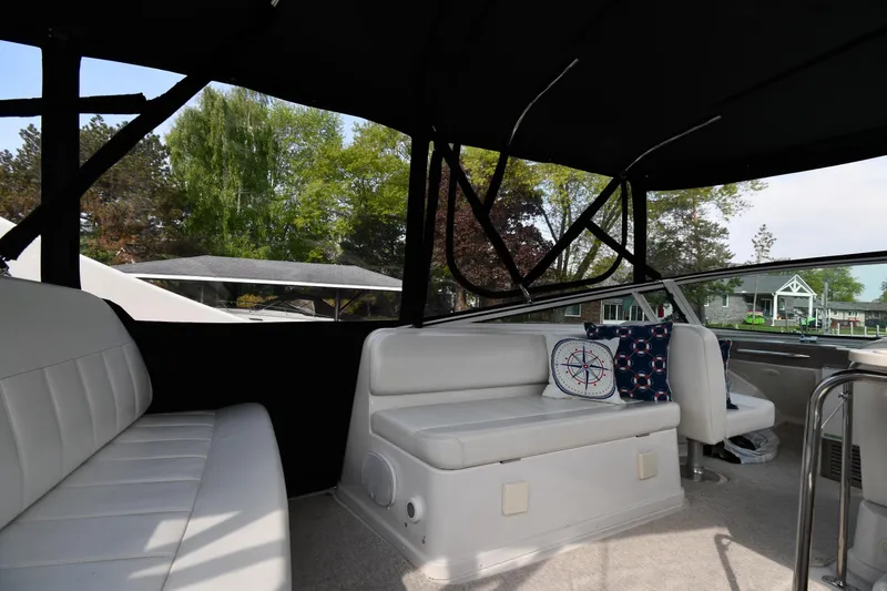 Slide: The Image of Interior of 2000 Carver 350 Mariner yacht with white seating and nautical-themed pillows. - 21