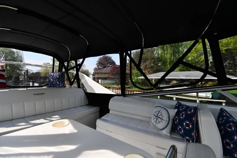 Slide: The Image of Interior view of 2000 Carver 350 Mariner yacht with cushioned seating and nautical-themed pillows. - 23