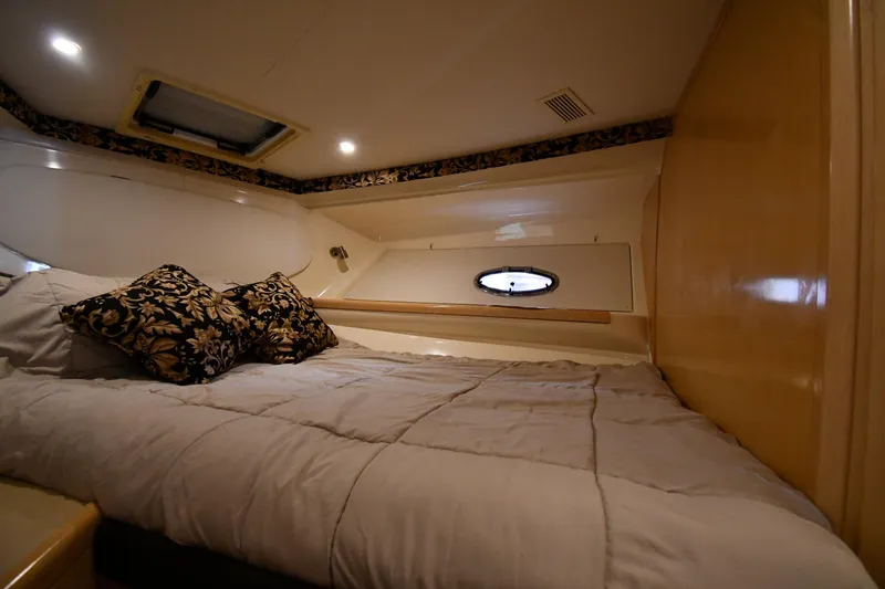 Slide: The Image of Cozy cabin interior of 2000 Carver 350 Mariner with elegant bedding and soft lighting. - 29
