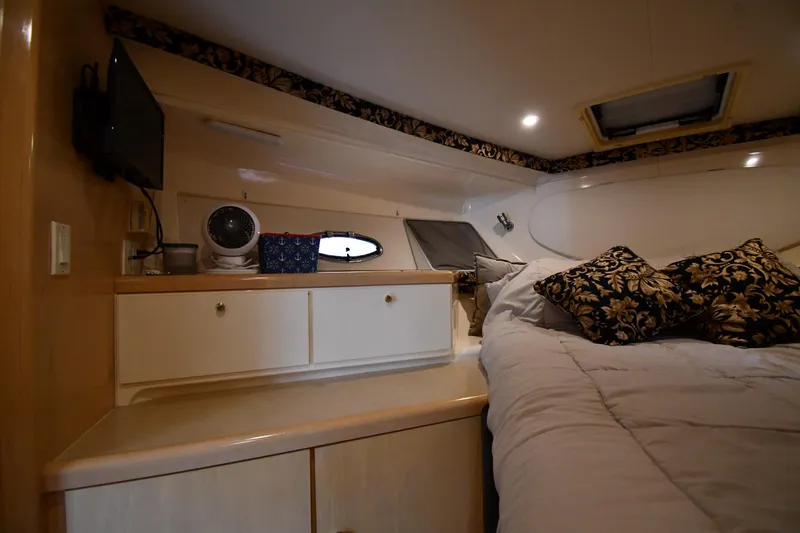 Slide: The Image of Interior cabin of 2000 Carver 350 Mariner with bed, pillows, and storage cabinets. - 30