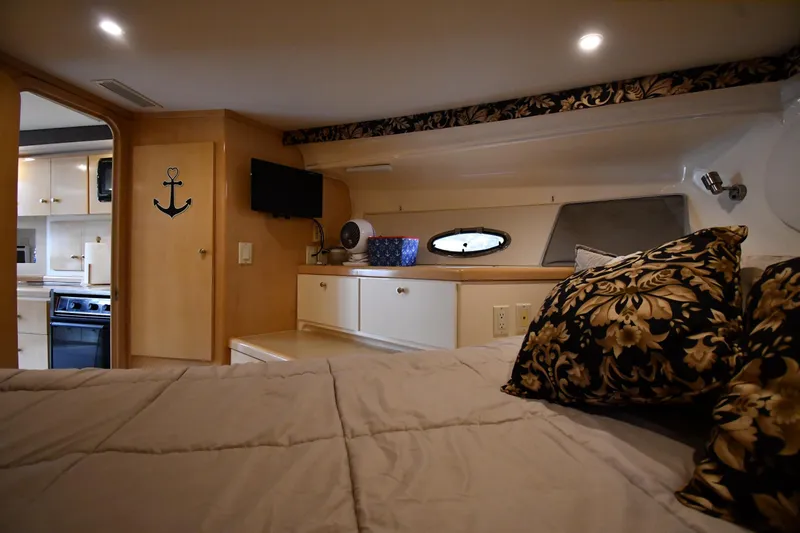 Slide: The Image of Interior of 2000 Carver 350 Mariner yacht with cozy bedroom and elegant decor. - 31