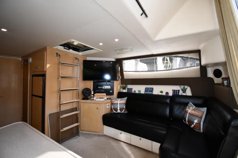 Slide: The Image of Interior of 2000 Carver 350 Mariner yacht with black leather seating and entertainment center. - 37