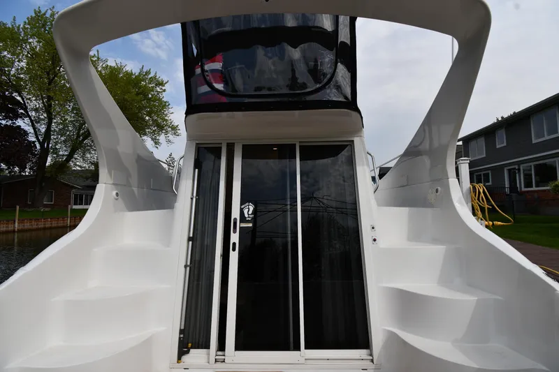 Slide: The Image of Carver 350 Mariner 2000 yacht with sleek white exterior and dual staircases. - 4