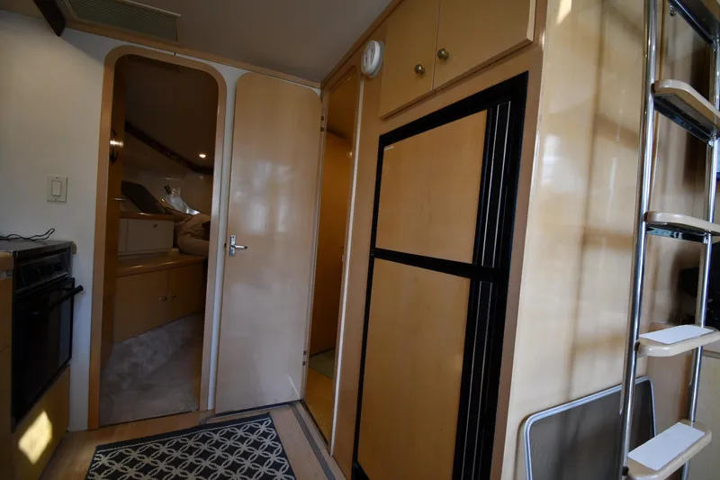 Slide: The Image of Interior of 2000 Carver 350 Mariner yacht, featuring kitchen and cabin entrance. - 42
