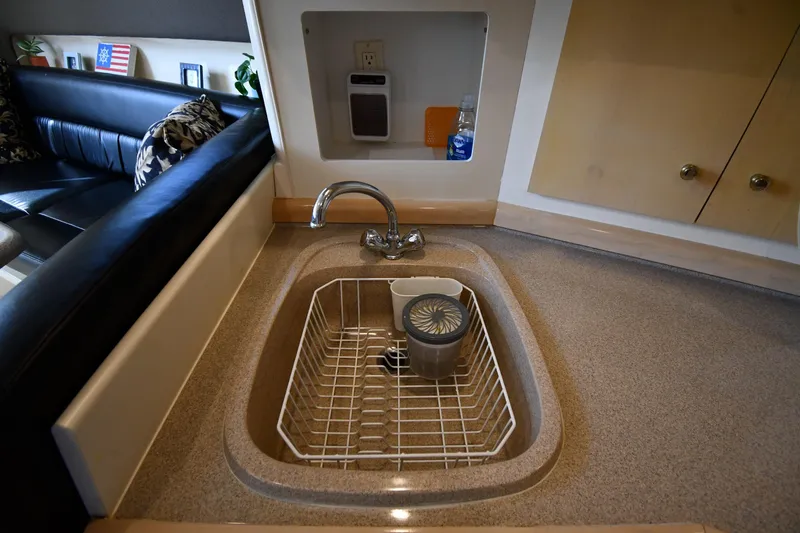 Slide: The Image of Interior of 2000 Carver 350 Mariner yacht showing kitchen sink and seating area. - 43