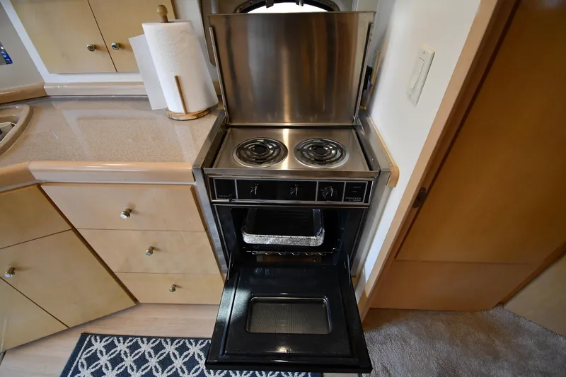 Slide: The Image of Compact kitchen stove and oven in 2000 Carver 350 Mariner yacht interior. - 44