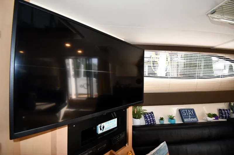 Slide: The Image of Interior of 2000 Carver 350 Mariner yacht with TV and decorative pillows. - 47