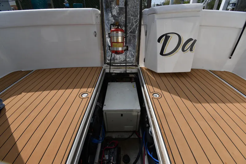 Slide: The Image of Carver 350 Mariner 2000 boat deck with open engine compartment and fire extinguisher. - 50