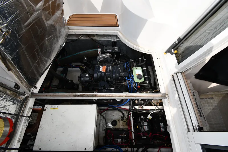 Slide: The Image of Engine compartment of a 2000 Carver 350 Mariner boat, showcasing mechanical components. - 51