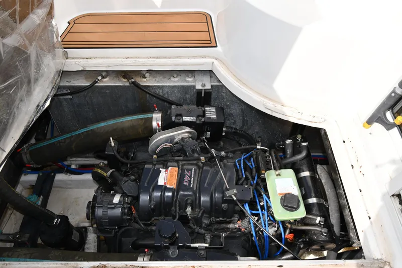Slide: The Image of Engine compartment of a 2000 Carver 350 Mariner boat, showcasing mechanical components. - 52