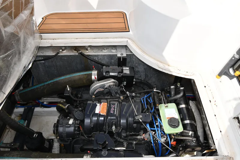 Slide: The Image of Engine compartment of a 2000 Carver 350 Mariner boat, showcasing mechanical components. - 53