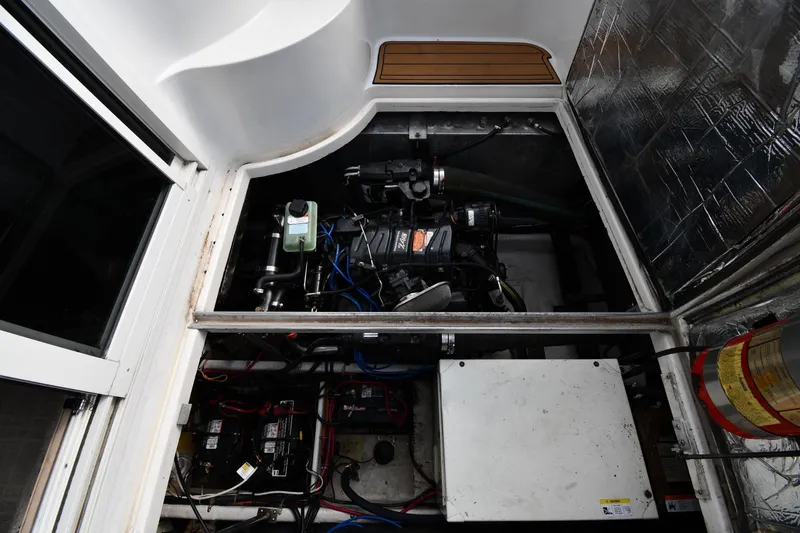 Slide: The Image of Engine compartment of a 2000 Carver 350 Mariner boat, showcasing mechanical components. - 54
