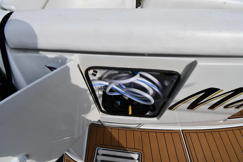 Slide: The Image of Storage compartment on a 2000 Carver 350 Mariner boat with coiled hoses. - 8