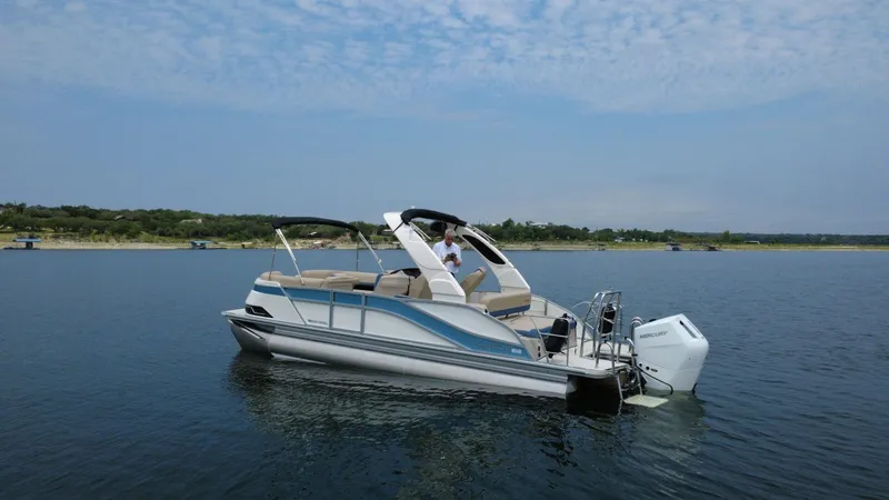 Slide: The Image of 2026 Harris Grand Mariner 230 pontoon boat on calm water. - 3