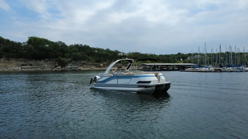 Slide: The Image of 2026 Harris Grand Mariner 230 on a tranquil lake. - 4