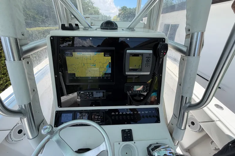 Slide: The Image of Center console of a 2005 Competition 25 boat with navigation equipment and controls. - 11