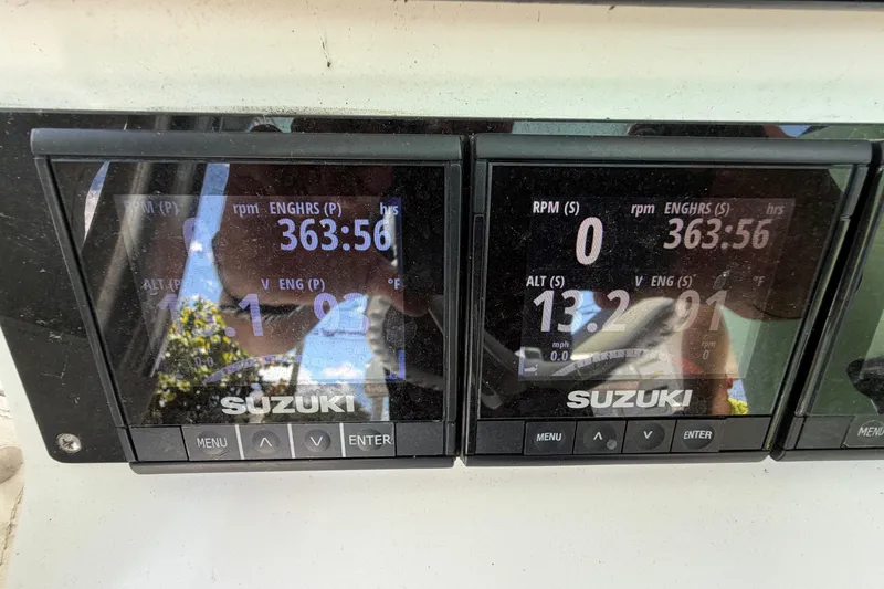 Slide: The Image of Digital display of Suzuki engine metrics on a 2005 Competition 25 boat. - 12