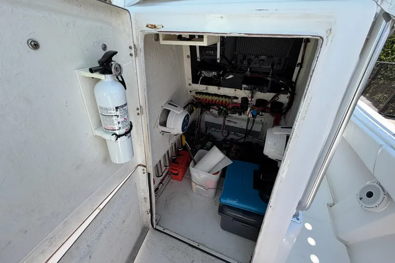 Slide: The Image of Electrical compartment of a 2005 Competition 25 boat with fire extinguisher and wiring. - 14