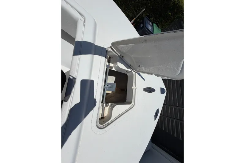 Slide: The Image of Open storage compartment on a 2005 Competition 25 boat, showing interior details. - 16