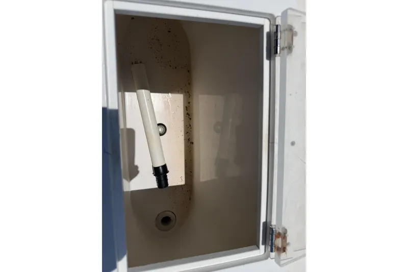 Slide: The Image of Open compartment of 2005 Competition 25 boat with drainage pipe. - 18