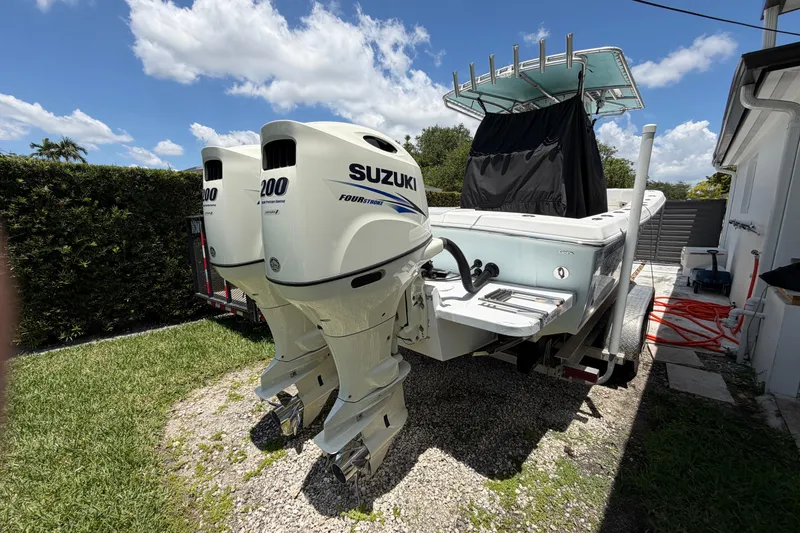 Slide: The Image of 2005 Competition 25 boat with twin Suzuki 200 outboard engines, parked outdoors. - 20